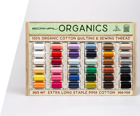 A display rack featuring a rainbow of 36 organic cotton threads from Scanfil